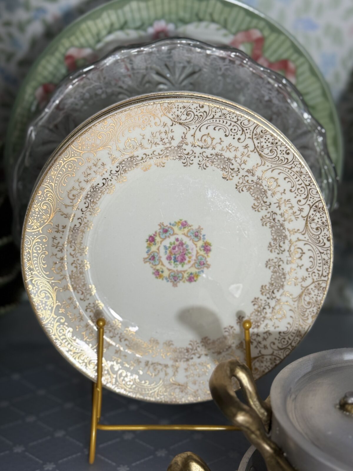 Ornate porcelain plate with gold filigree, perfect for a hosting closet or hall linen closet display.