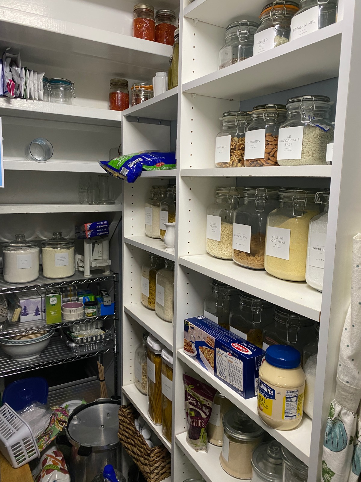 Organized pantry with labeled jars and supplies—perfect inspiration for your hosting closet or hall closet makeover.