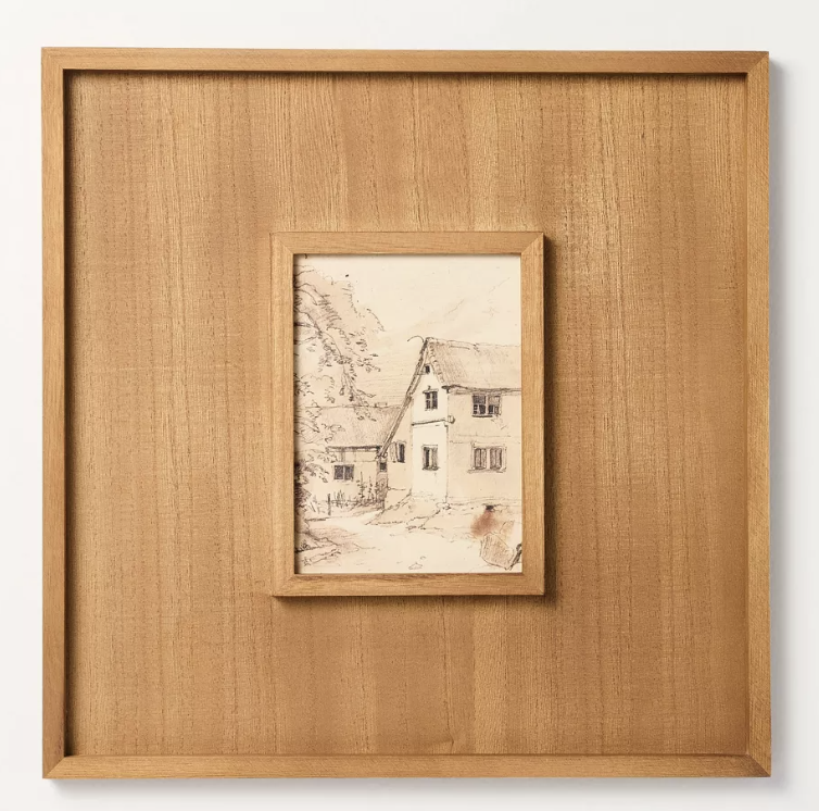 Framed sketch of a house with trees, ideal for shopping enthusiasts seeking unique decor in a wide wooden frame.
