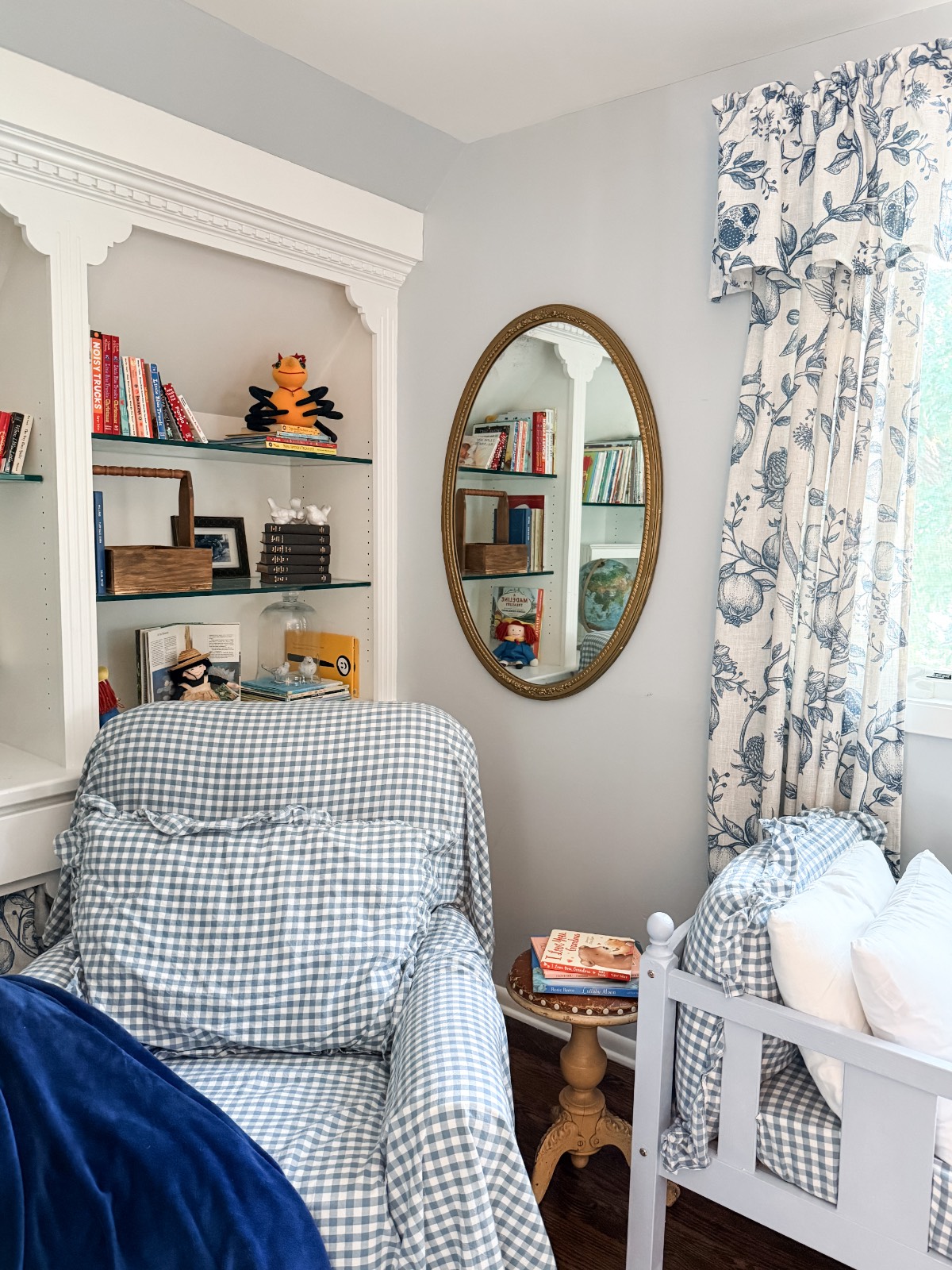 Cozy reading nook in the third bedroom of a family suite, with checkered armchair and floral curtains in soft light.