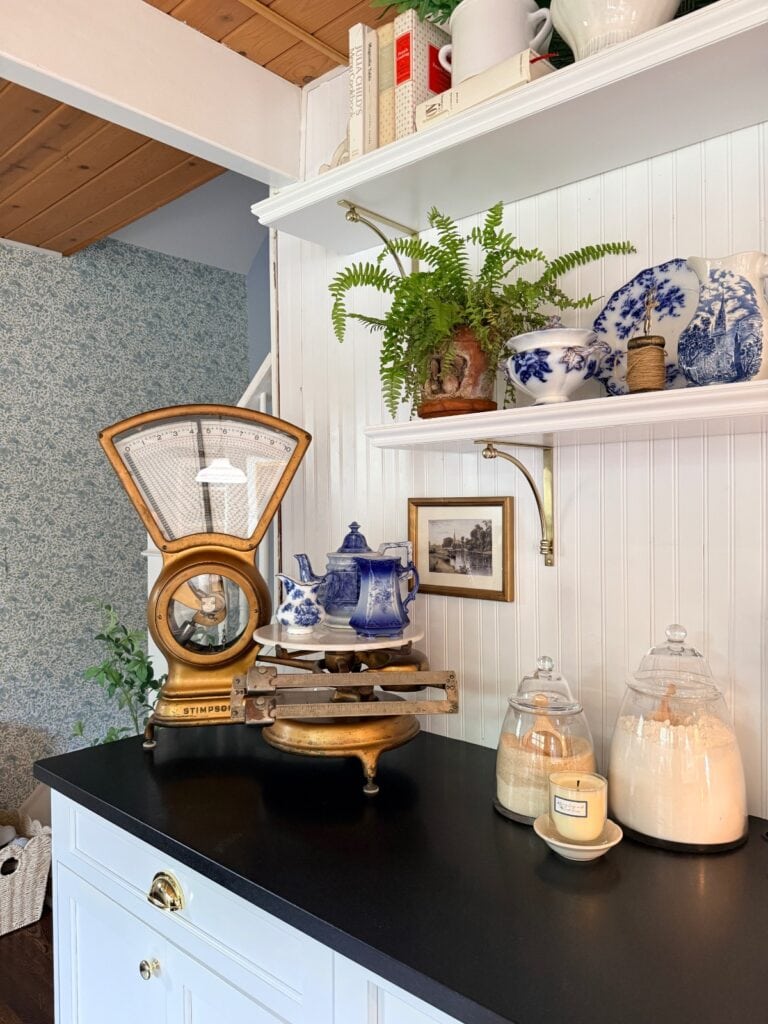 Vintage kitchen scale, blue teapot, and jars—decide what things to throw away right now for a clutter-free space.
