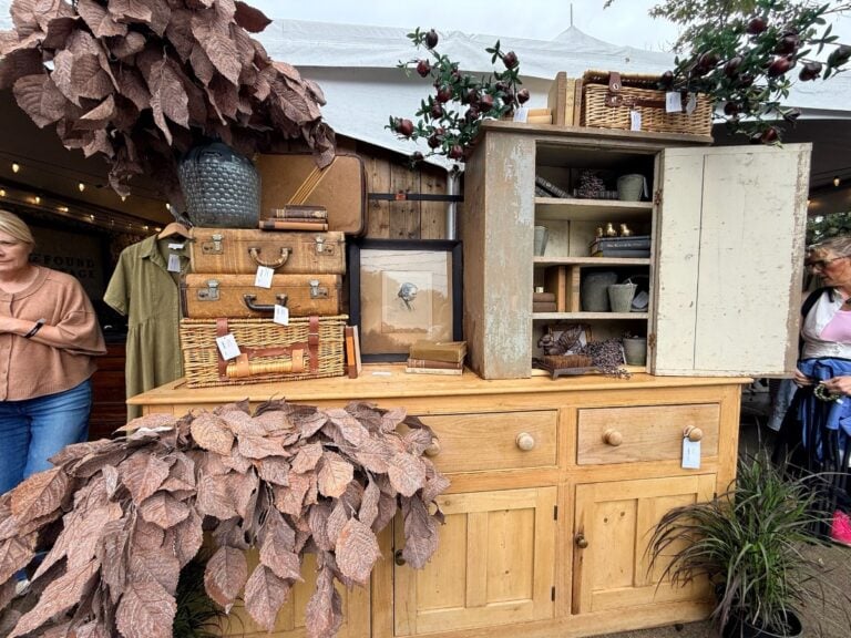 Curated vintage booth with furniture and vintage wares at a Michigan vintage market