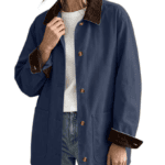 Woman shopping in a blue jacket with brown collar and cuffs, white shirt, and classic blue jeans.