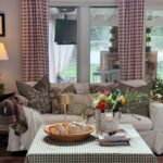 Cozy living room with a white sofa, plaid curtains, and muted fall decor for a charming vintage fall home tour feel.