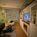 9 ft unlit King Noble Fir wrapped in firecracker lights in a Chicago loft.